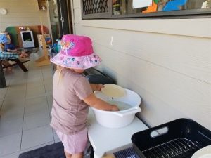 Child washing a plate - Cleveland Early Learning Centre