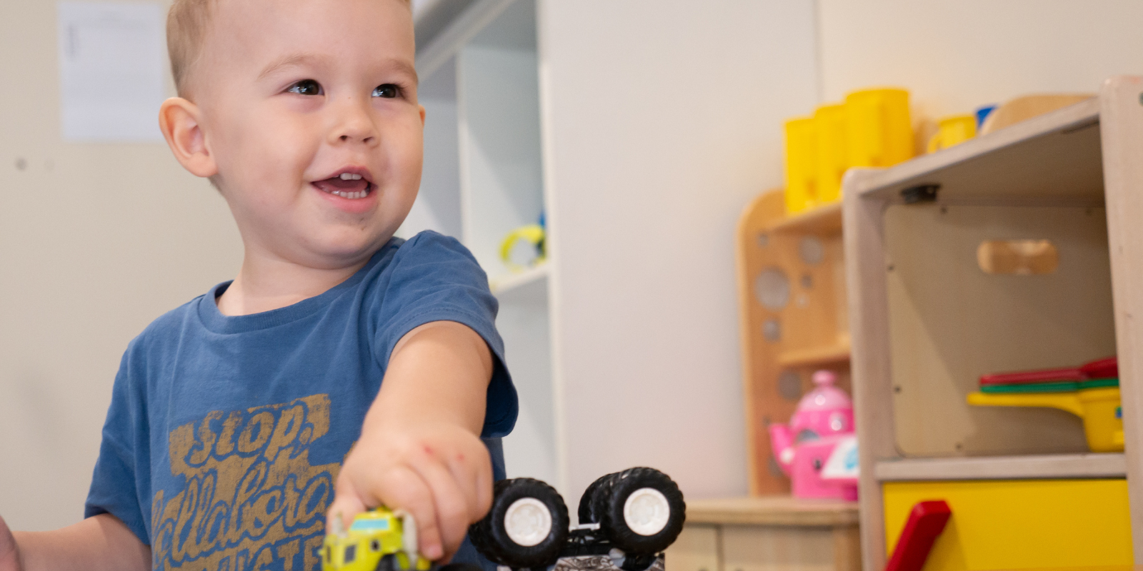 Learning_Through_Play Kid Playing Toy Truck - Your ELC