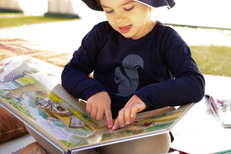 A Kid Reading a Story Book -Importance of Storytelling - Your Early Learning Centre Blog Image