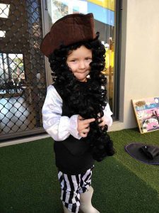 A kid in a pirate costume smiling at the camera - Early Learning Centre Cleveland September 2021 Newsletter Image