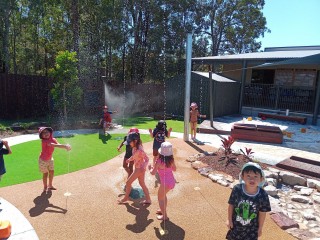 Kids playing in the water outside - Doolandella Newsletter 2021 - Your ELC