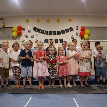 Kids in the platform performing their graduation song - Your ELC