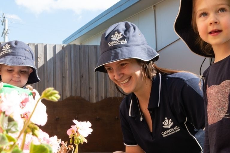 jan-blog-5 ways children benefit from going to childcare Kids and their teacher outside looking at flowers - Your ELC Blog Image