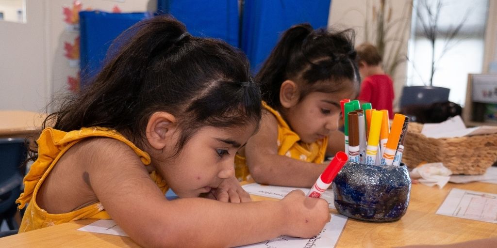 jan-blog-FAQs About Kindergarten Your Questions Answered. Kids in the centre colouring a paper with markers - Your ELC Blog Image