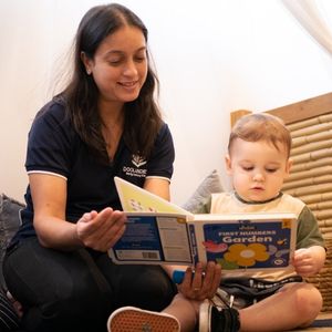 Teacher reading a book to a kid - Your ELC Doolandella