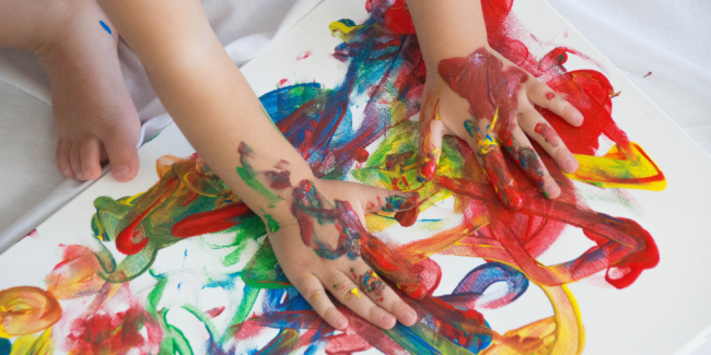 The Benefits of Messy Play Kid's hand full of paint - Benefits of Messy Play - Your ELC