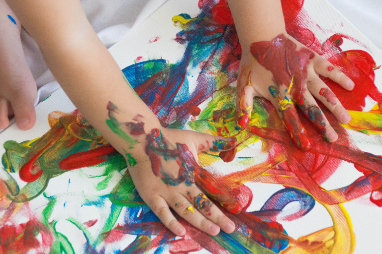 The Benefits of Messy Play Kid's hand full of paint - Benefits of Messy Play - Your ELC