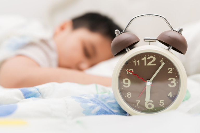 Why Routines Are Important for Children A sleeping kid with an alarm clock - Your ELC