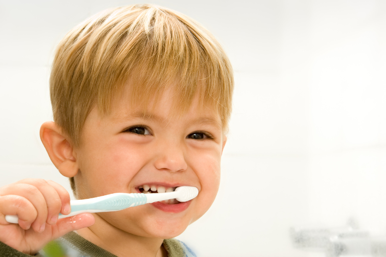 A kid brushing his teeth - Your ELC