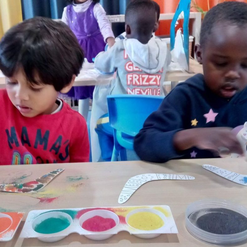 Kids doing different activities on the table - Doolandella July 2022 Newsletter