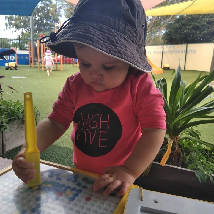 A child playing with a toy outdoors - your ELC
