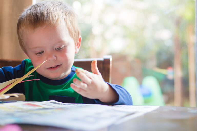 School Holidays Blog A child reading on a table - Your ELC blog image