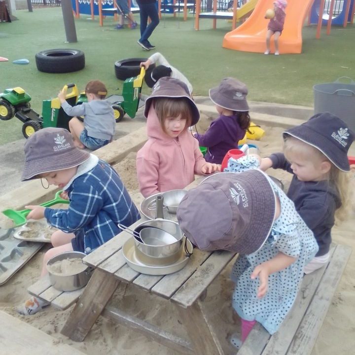 Children enjoying playtime outdoors in the sand - Your ELC image