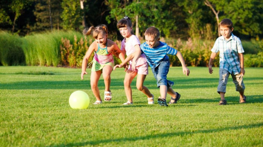 4 kids playing ball outdoor - Your ELC newsletter image