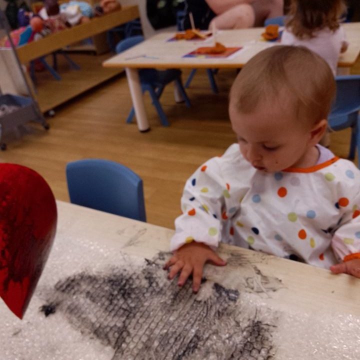 Child playing with black paint | Your ELC blog image