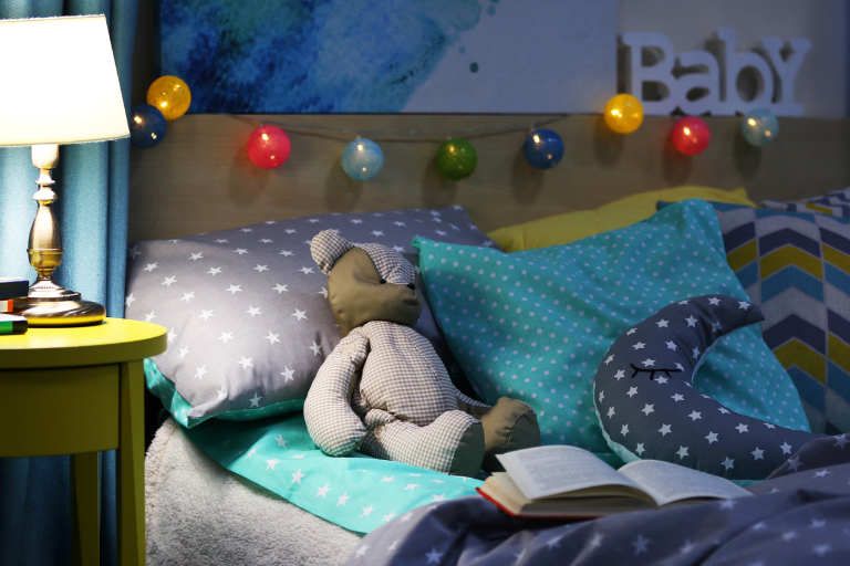 Soothing Bedtime Routine Child's bedroom with books and lamp on bedside table | Your ELC blog image