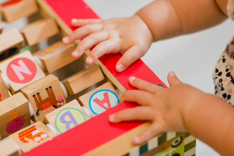 Creating a Safe and Stimulating Childcare Environment child playing on educational toy | Your ELC blog image