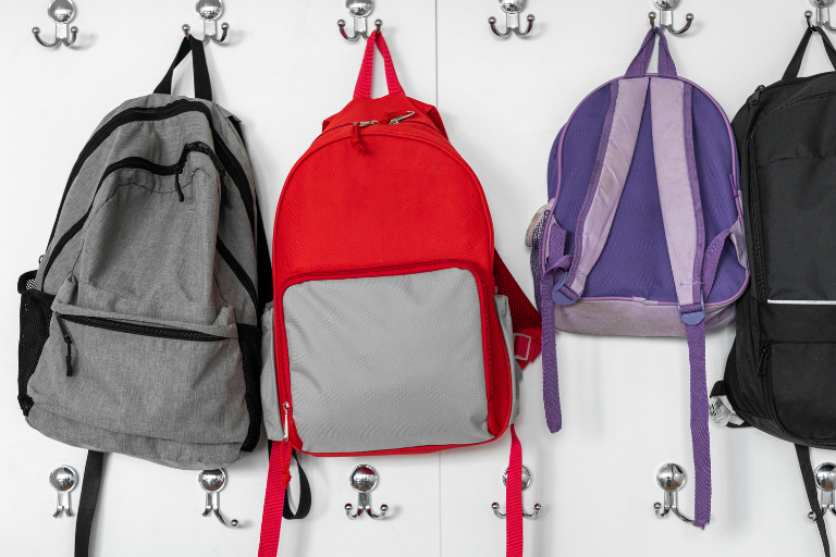 How Childcare Centres Help Children Transition to School bags hanging on hooks | Your ELC blog image