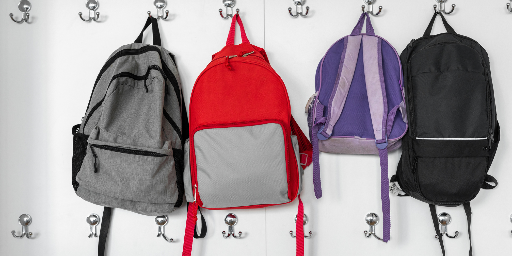 How Childcare Centres Help Children Transition to School bags hanging on hooks | Your ELC blog image